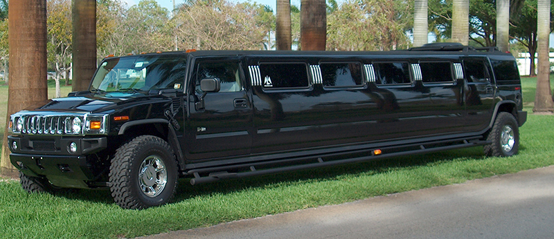 A black limo parked on the side of a road.