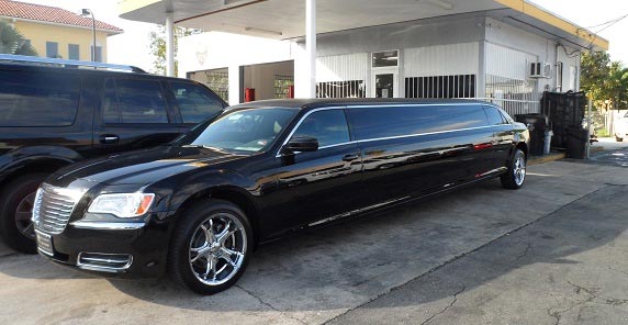 A black limo parked in front of a building.