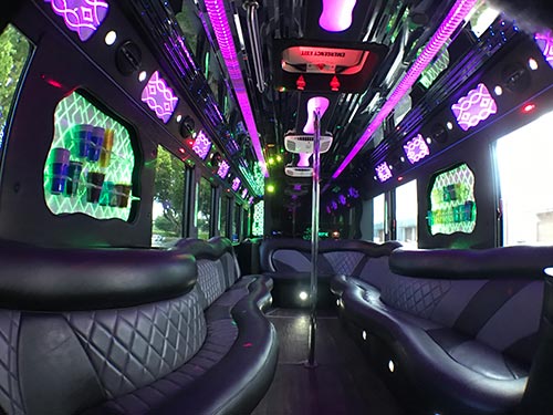 A large bus with many seats and lights on it