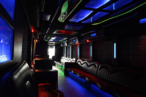 A bus with many seats and lights on the ceiling