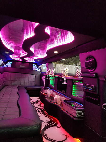 A limo with pink lights and purple lighting.