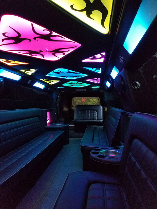 A limo with lights on the ceiling and seats.