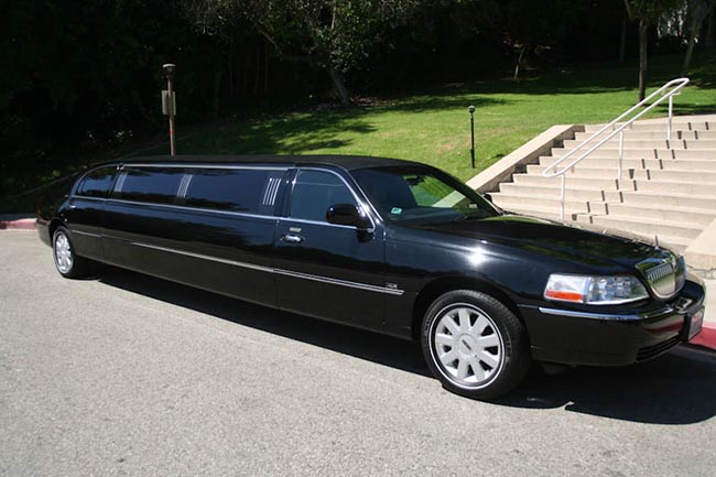 A black limo is parked in the street.