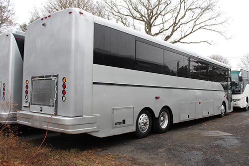 A large white bus parked in the parking lot.