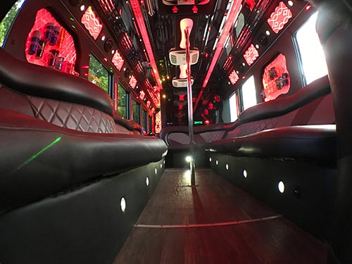A view of the inside of a bus with red lights.
